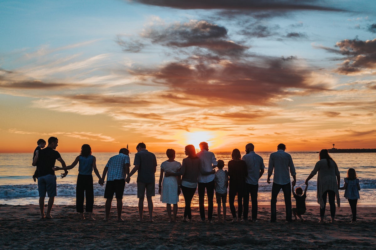 Multigenerational family together at sunset